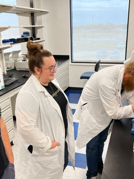 Scientists gather around a DS-11 Spectrophotometer at TxGen