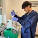 A graduate student in the Wise Laboratory prepares a sample to load onto the CellDrop Automated Cell Counter