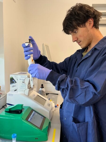 A graduate student in the Wise Laboratory prepares a sample to load onto the CellDrop Automated Cell Counter