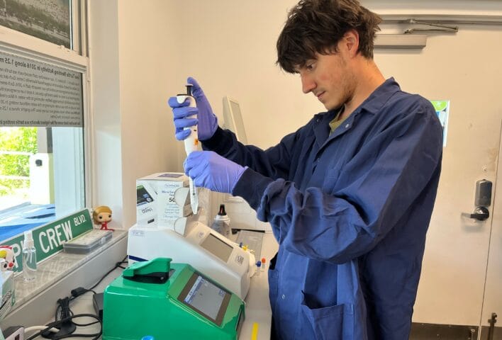 A graduate student in the Wise Laboratory prepares a sample to load onto the CellDrop Automated Cell Counter
